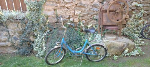 a blue bike parked next to a stone wall at Villa Old House BN in Bitola