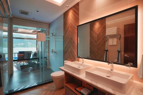 a bathroom with two sinks and a large mirror at Gayana Marine Resort in Gaya Island