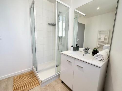 Un baño blanco con ducha y lavabo. en L'AUTHENTIQUE - Moderne - Central, en Mont-de-Marsan