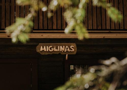a sign that reads mitzamines hanging from a building at Holiday home Migliņas in Kaugurmuiza