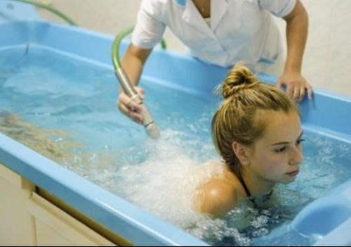 a woman in a bath tub with a girl in it at Villa Kameliya in Truskavets