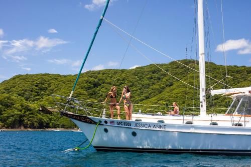 a group of people on a sail boat in the water at Villas Sol Beach Resort in Playa Hermosa