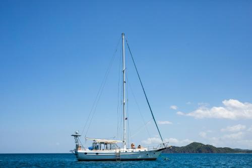 a sailboat in the ocean on the water at Villas Sol Beach Resort in Playa Hermosa