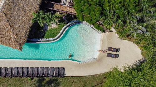 an overhead view of a swimming pool next to a beach at Villas Sol Beach Resort in Playa Hermosa
