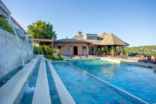 a swimming pool in front of a house at Villas Sol Beach Resort - All Inclusive in Playa Hermosa