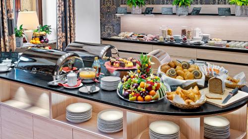 a breakfast buffet with food on a table at Hotel Bayerischer Hof Dresden in Dresden