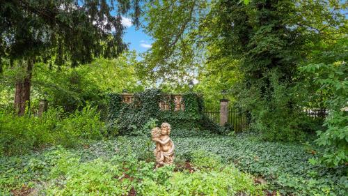 a statue of a tiger standing in a garden at Hotel Bayerischer Hof Dresden in Dresden