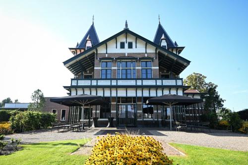 a large house with a gambrel roof at Wapen van Hengelo Residence Suites - digital key by SMS and email in Hengelo