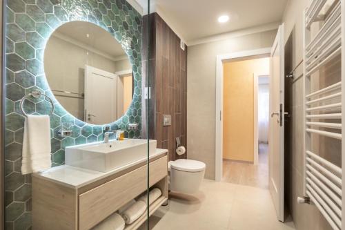 a bathroom with a sink and a mirror at 5th Floor Executive Apartment with Balcony and Free Parking in Braşov