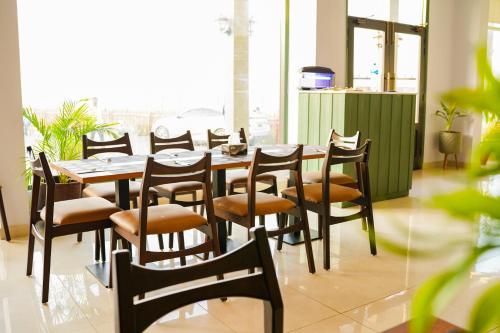 a dining room with a table and chairs at Destination Beach Hotel by Dreamworld in Karachi