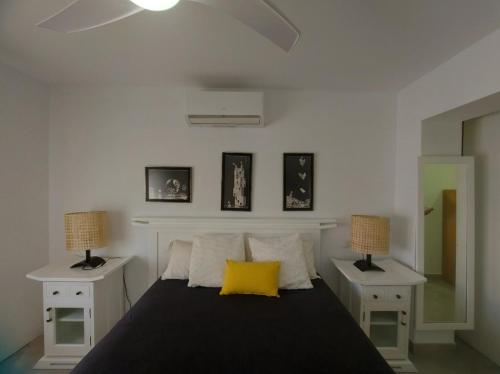 - une chambre avec un lit doté d'un oreiller jaune dans l'établissement Casa turquesa, à Valencina de la Concepción