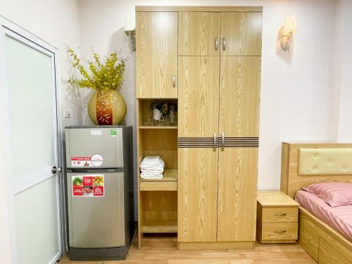a small room with a refrigerator and a cabinet at Joy Homestay in Hanoi