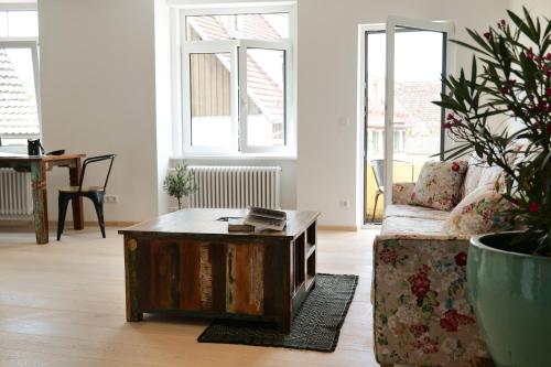 a living room with a couch and a coffee table at Goldener Löwe in Bodman-Ludwigshafen