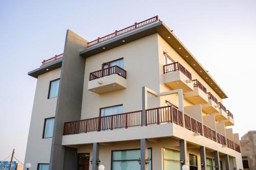 a building with balconies on the side of it at Destination Beach Hotel by Dreamworld in Karachi