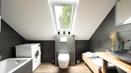 a bathroom with a toilet and a sink and a window at 3,5-Zimmer inkl Arbeitsplatz, WLAN & free Netflix, Amazon-Free Parken vollausgestattete Wohnung, 24h Check In in Hamm