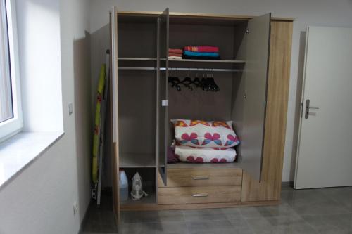 a closet with wooden drawers in a room at 2- Zimmer-Wohnung in Weilerswist