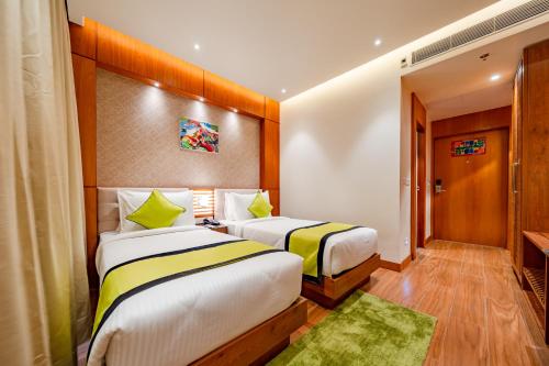 a hotel room with two beds in a room at Payel Inn in Āsansol