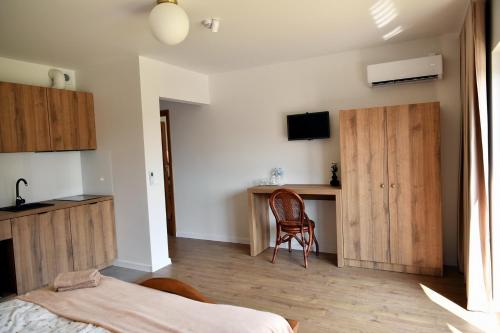 a bedroom with a bed and a desk and a chair at Dobranocka Noclegi - blisko Energylandia in Spytkowice