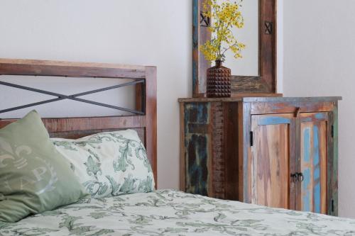 a bedroom with a bed and a mirror at Goldener Löwe in Bodman-Ludwigshafen