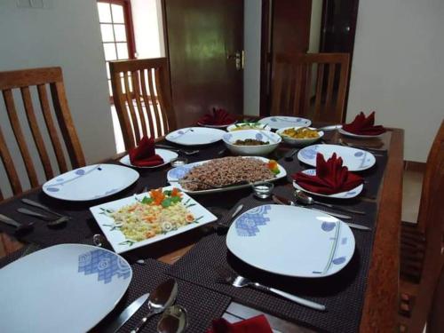 een tafel met borden en kommen met eten erop bij Diyagal Villa 