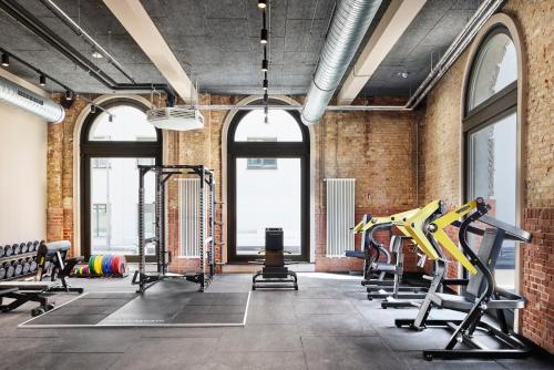 a gym with treadmills and exercise equipment at Telegraphenamt in Berlin