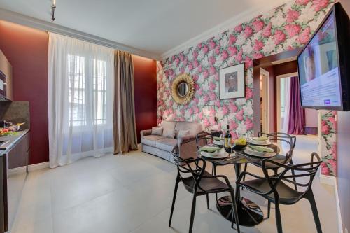 a living room with a table and a couch at Seven Suites Apartments - Via Matteotti 178 in Sanremo