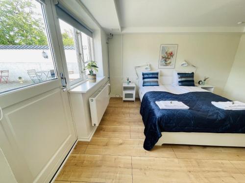 a bedroom with a bed and a large window at aday - 2 Bedroom apartment close to Aalborg Hospital in Aalborg