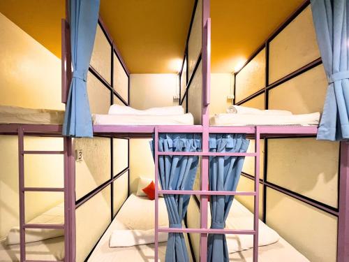 a bunk bed room with two bunk beds at Sleepy Station Hostel in Kata Beach