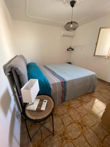 a bedroom with a bed and a table with a table at margherita house in Avola