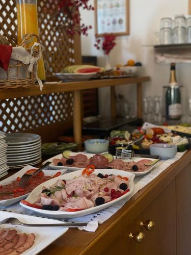 a buffet with many plates of food on a table at Pension Rucksackpeter in Hohenbrugg an der Raab