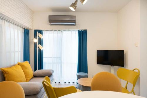 a living room with a couch and a tv at Kisa in Tokyo