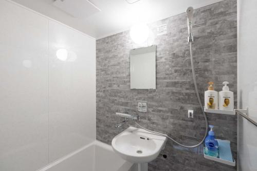 a bathroom with a shower and a toilet and a sink at Kisa in Tokyo