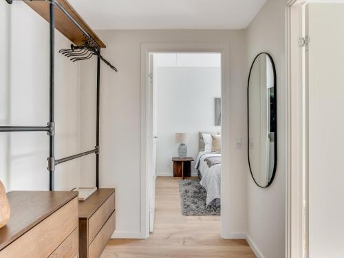 a hallway with a mirror and a bedroom at Sanders View Copenhagen - Stunning Two-Bedroom Apartment with harbor view in Copenhagen