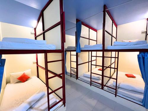 a group of bunk beds in a room at Sleepy Station Hostel in Kata Beach