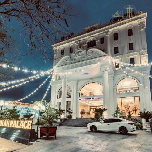 a white car parked in front of a building with christmas lights at Tan An Palace in Hai Phong