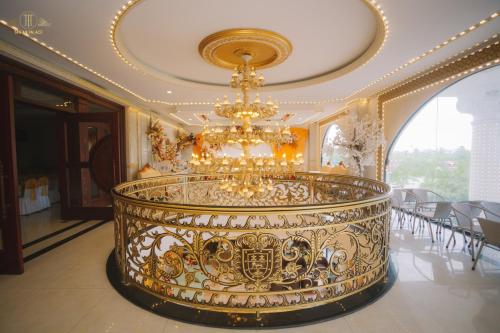 a large room with a chandelier in a building at Tan An Palace in Hai Phong