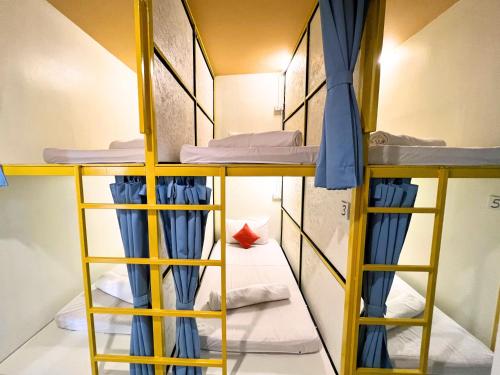 a group of bunk beds in a room at Sleepy Station Hostel in Kata Beach