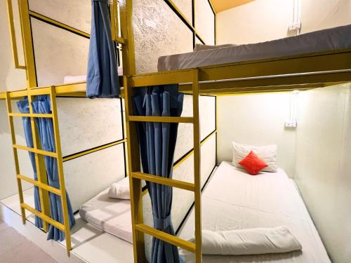 a room with bunk beds in a hostel at Sleepy Station Hostel in Kata Beach