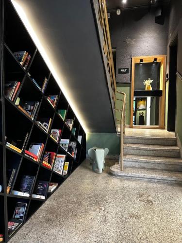 a staircase in a room with bookshelves at Levinski Market Hotel in Tel Aviv