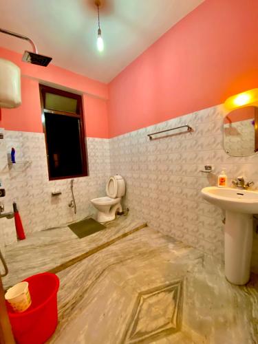 a bathroom with a toilet and a sink at Tashila Hostel in Gangtok