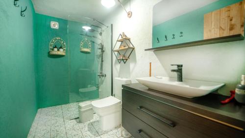 a bathroom with a sink and a shower and a toilet at Cozy Oasis with Lovely Backyard in Fethiye in Fethiye