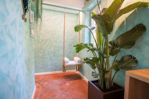 een badkamer met een potplant en een raam bij PgRhome Luxury Apartments Colosseo 11 BLU in Rome