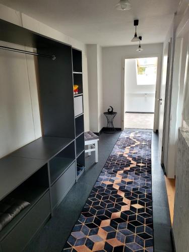 a kitchen with black cabinets and a tile floor at gemütliche Ferienwohnung in Burgstaedt