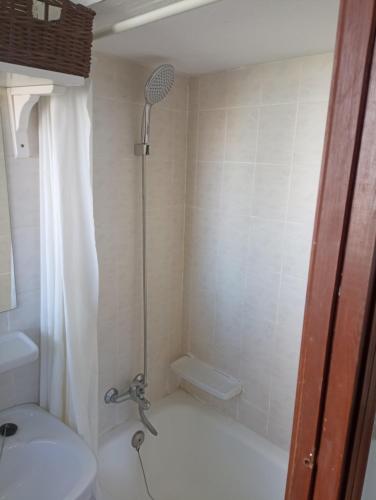 a bathroom with a shower with a toilet and a sink at Estudio Sota-Piscina in Denia
