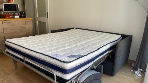 a mattress on a bed frame in a room at Studio plein centre avec garage et gardien in Grenoble