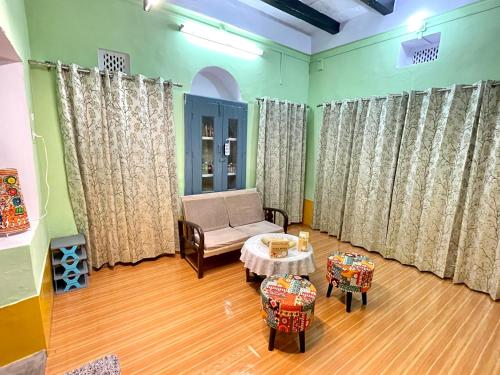 a living room with a couch and a table at Airbnb x Divine Stay in Mathura