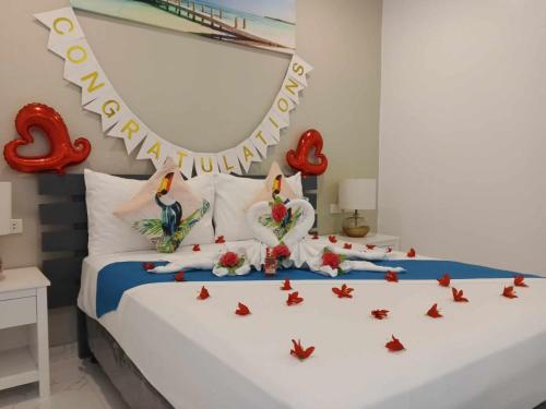 a bedroom with a bed with a happy birthday sign on it at Selectum Mangrove Resort in Panglao