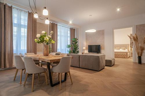 a living room with a table and chairs and a couch at Sting Old Town Ostrava in Ostrava