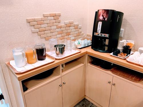 a kitchen with a coffee maker on a counter at Business Hotel Ekimae in Hakodate