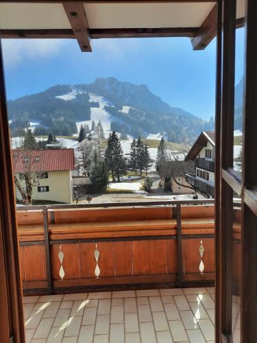 a window with a view of a mountain at Landhaus Müller in Jungholz